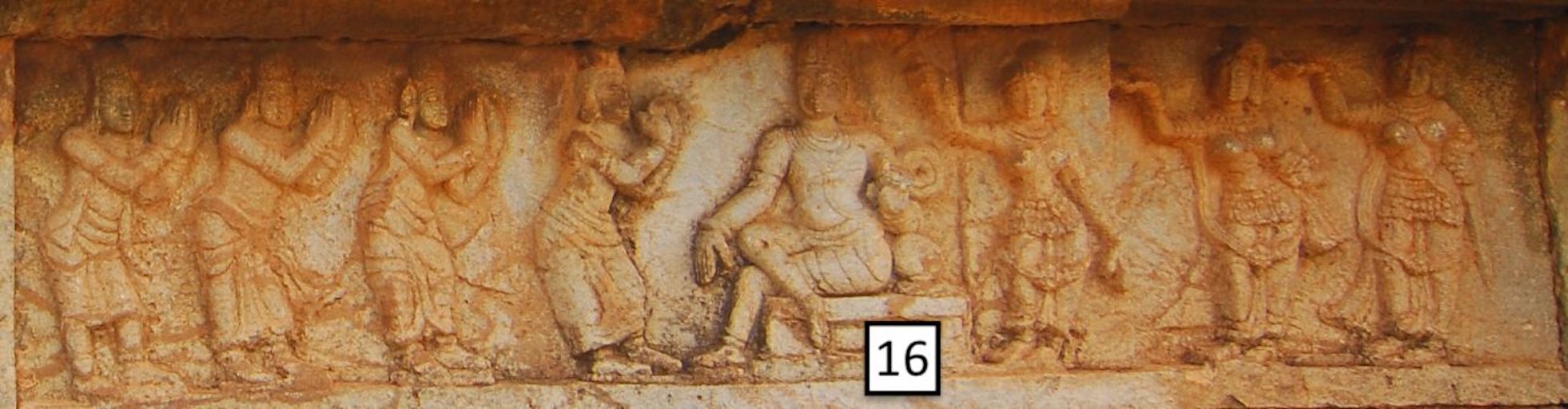 stone frieze with seated central figure and standing figures