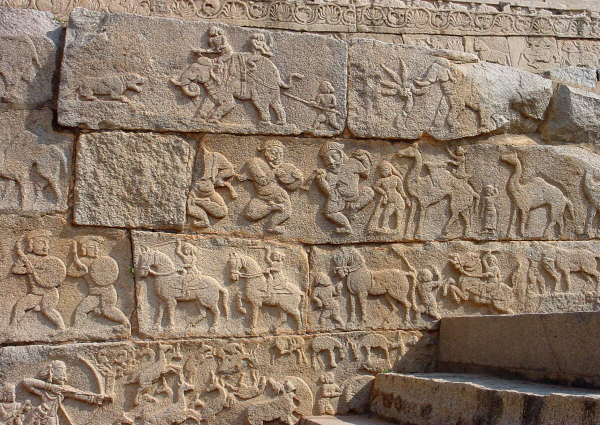 detail of stone carvings showing horse procession and Turkish dancers