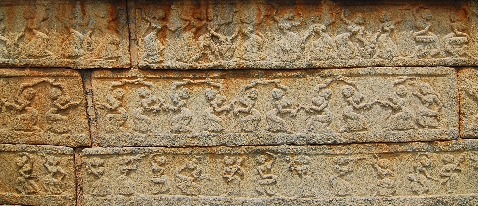 stone carving with three rows of dancing women