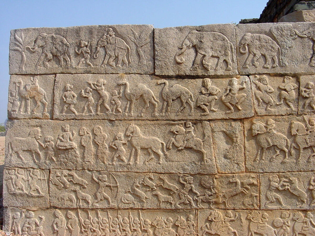 Mahanavami Dibba - detail military procession, hunting, horsemen, dancers stone carving featuring scenes of royal procession, hunting, dancing, and animals