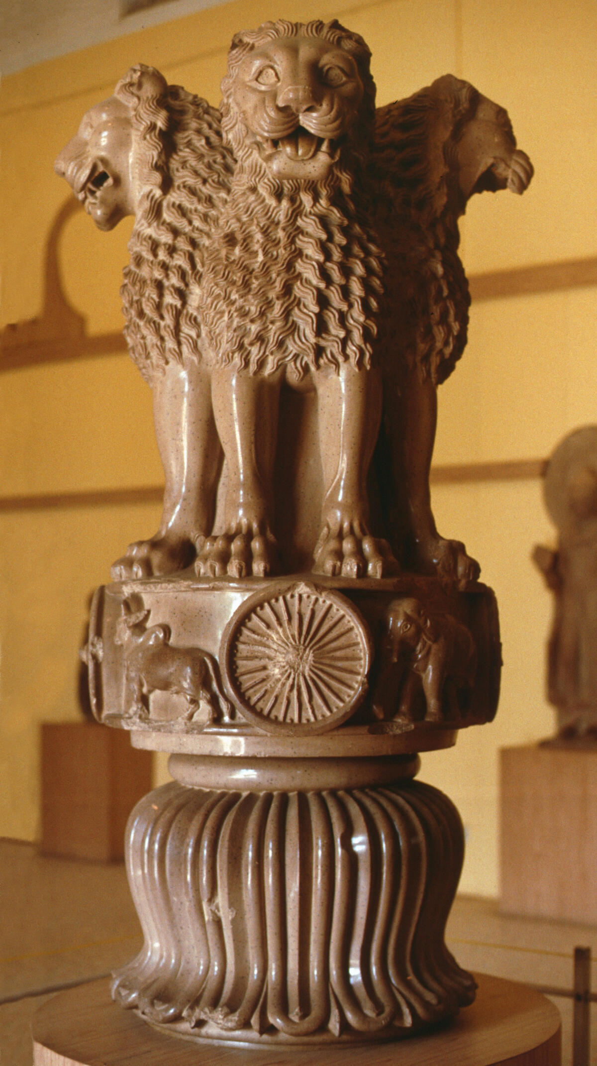 sculpture with lions, dharmachakra and lotus