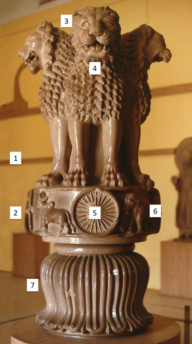sculpture with lions, dharma chakra, and lotus