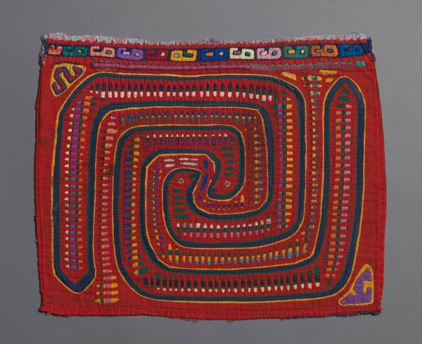 multicolored textile with geometric design in similar shape to carved stone, known as La Mola